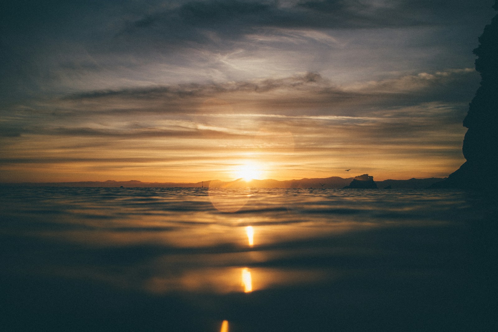 body of water during sunset
